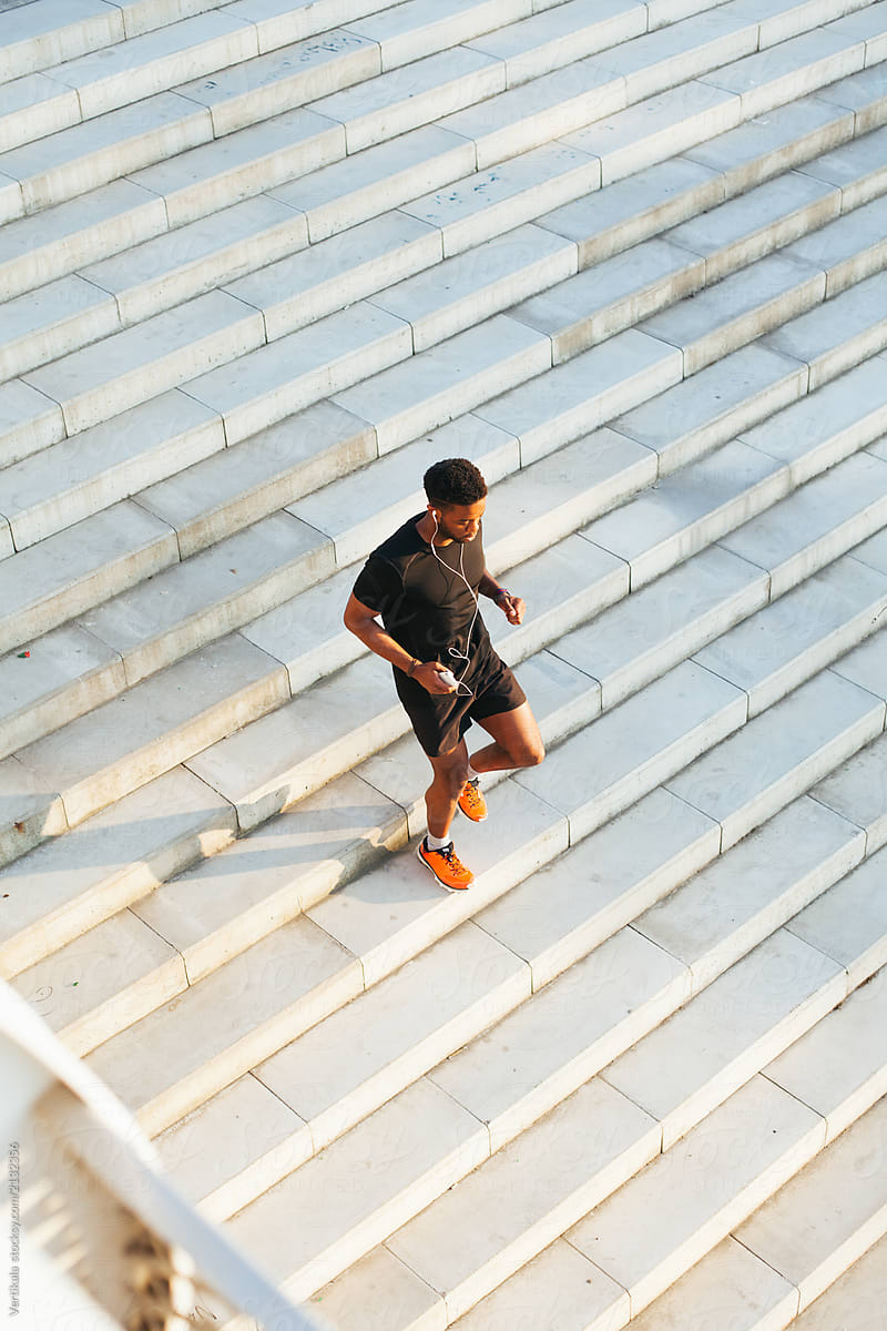 Handsome African American man running on stairs